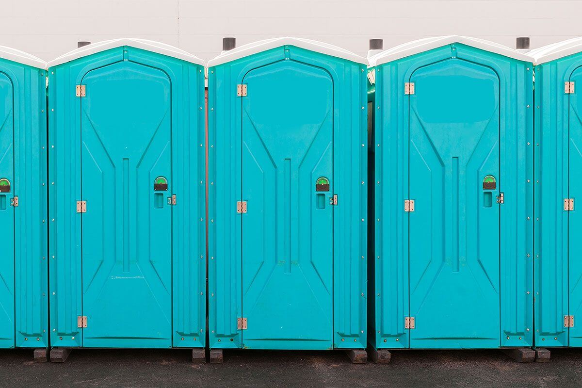 Industrial portable restroom units at a plant in Garland, Texas